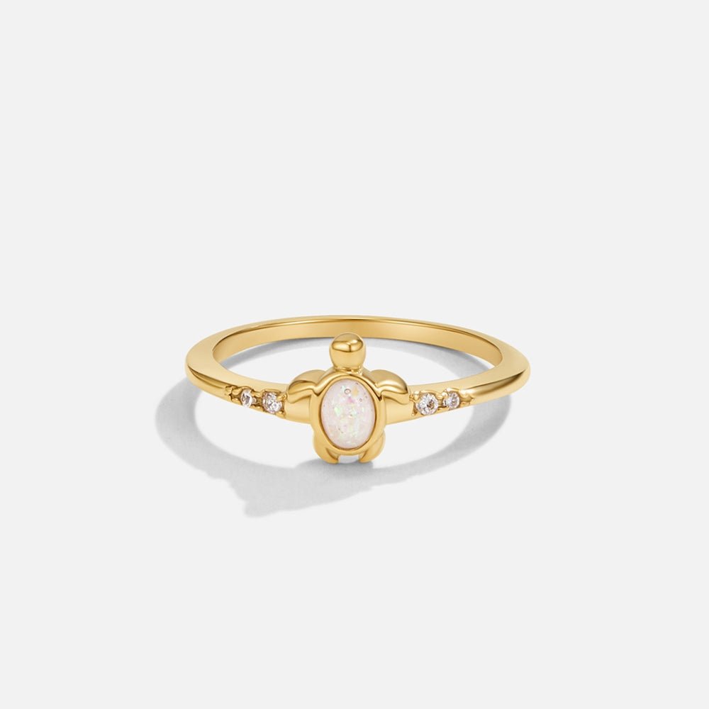 Opal Gold Turtle Ring, gold ring with a turtle front set with white opal, on white background