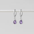 Silver Purple Teardrop Earrings, hanging from a silver rod on a grey background, side by side