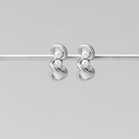 Tara Silver Entwined Pearl Earrings, pair of silver earrings with two small pearls each, hanging on a silver bar