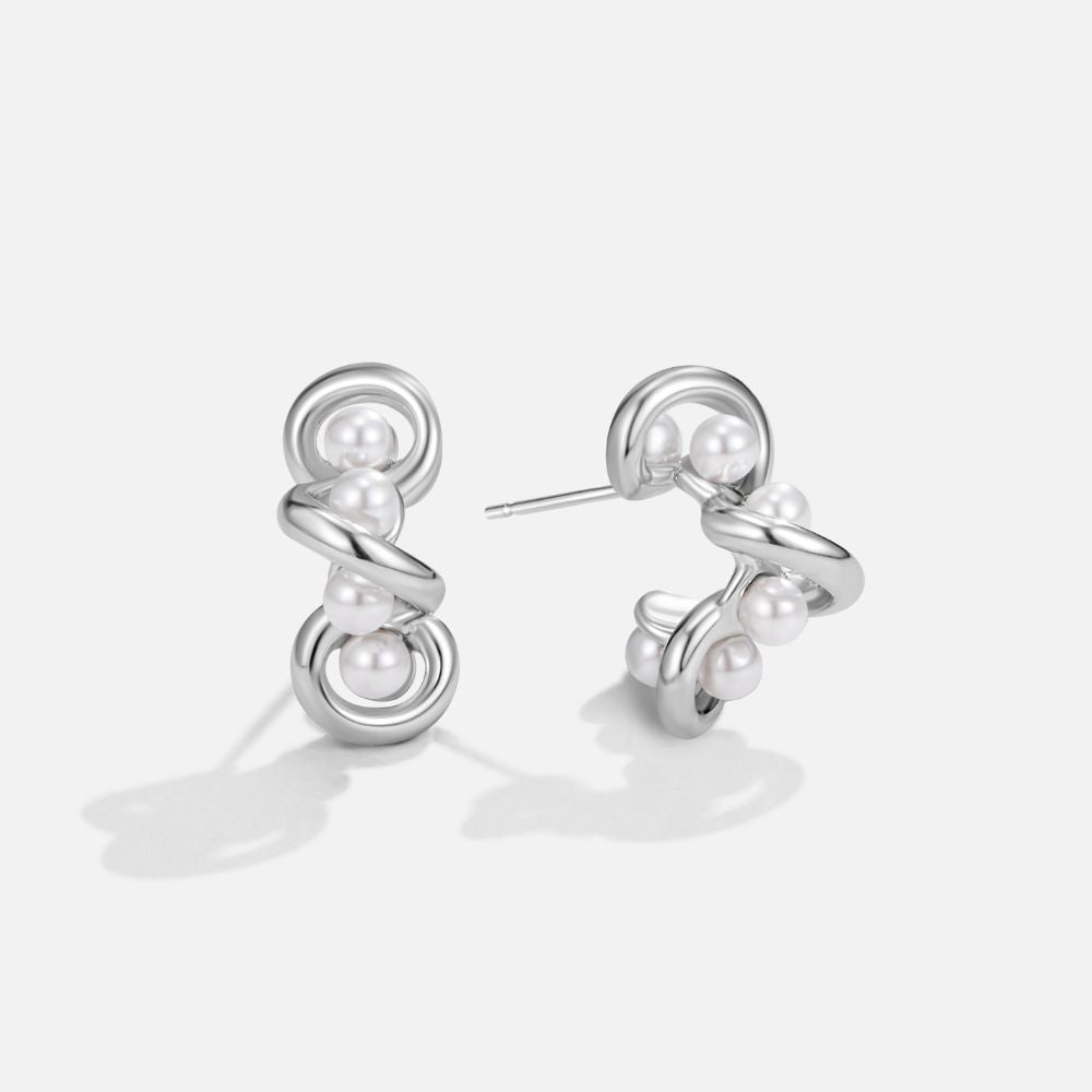 Tara Silver Entwined Pearl Earrings, pair of silver earrings on a plain white background, with pearls set in looping wire